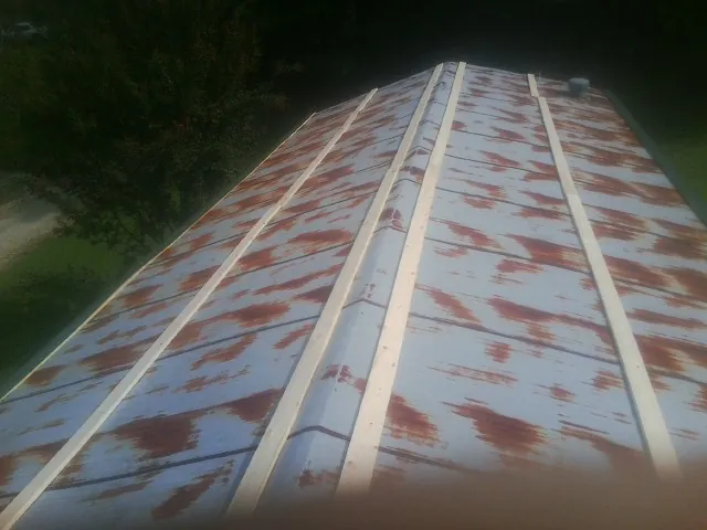 Rusted metal roof panels with new wood purlins before replacement — Storm Damage Roof Repair in Yantic by Roofing Brothers