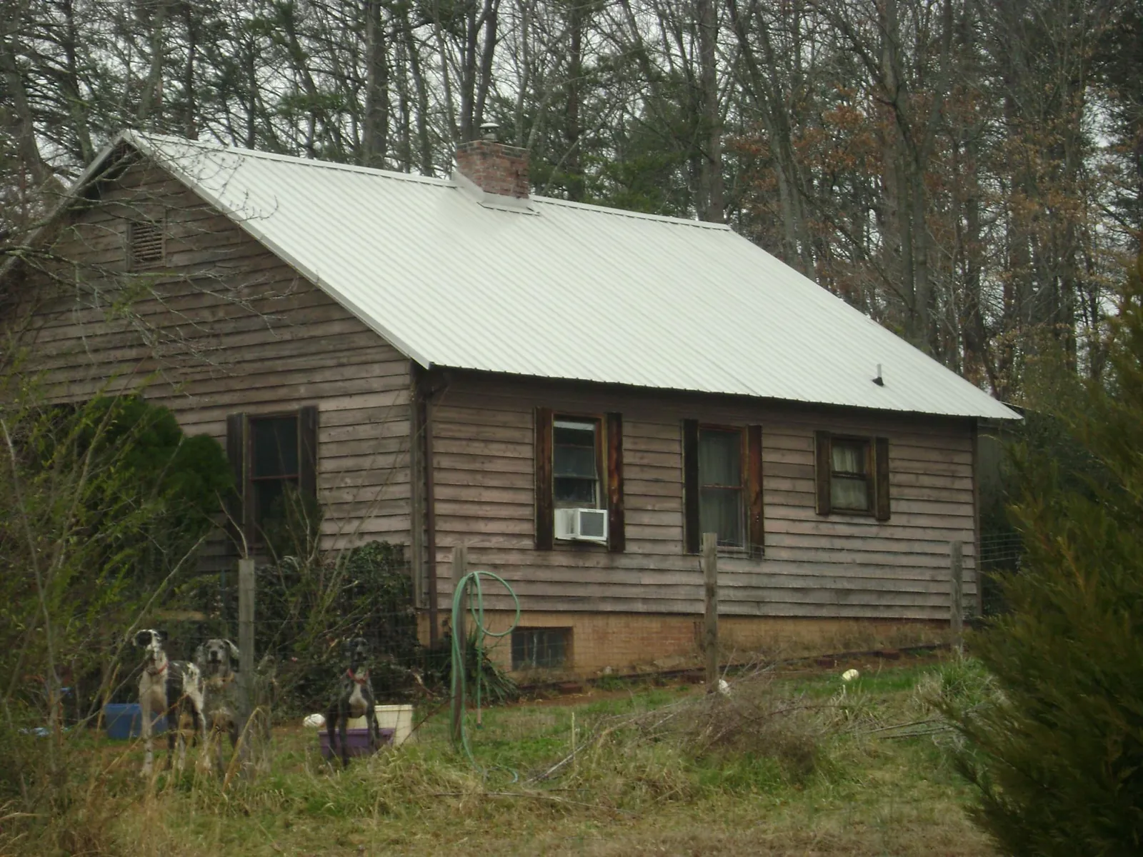 White metal roof on an old wood sided farmhouse, from a Metal Roof Installation job in Yantic